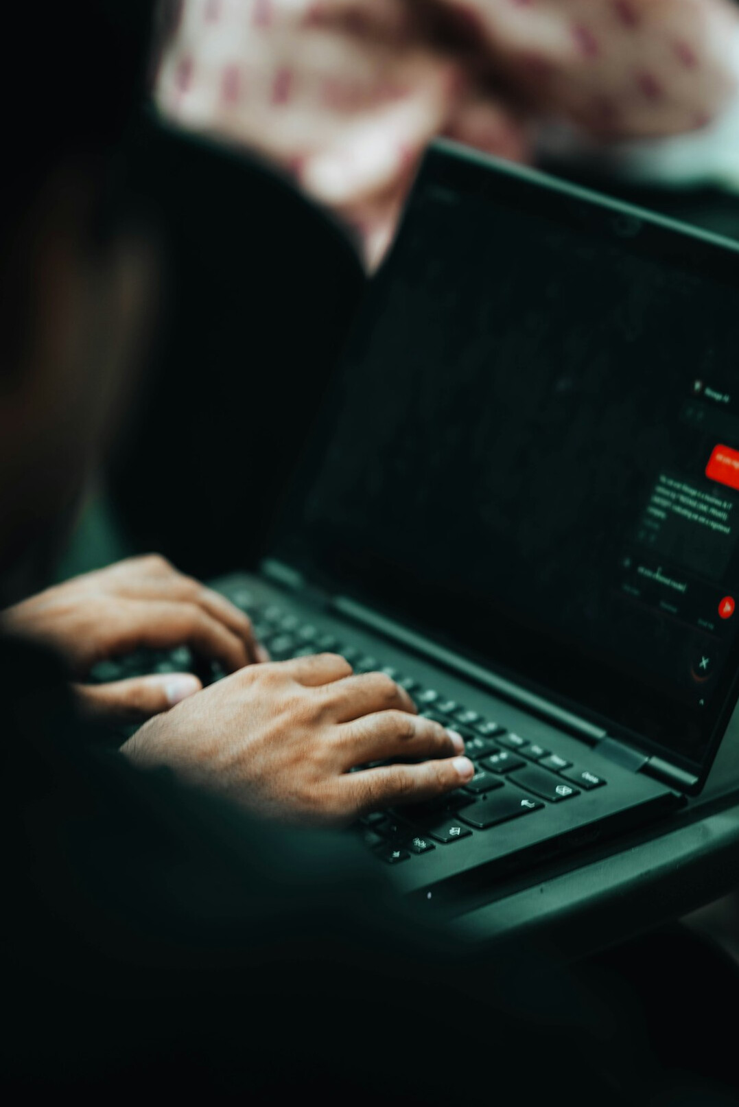 person coding on laptop
