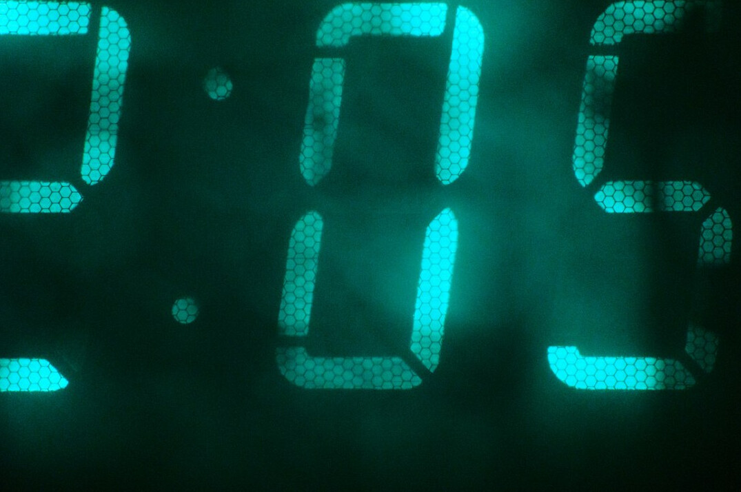 Stream of green digital characters on a dark background